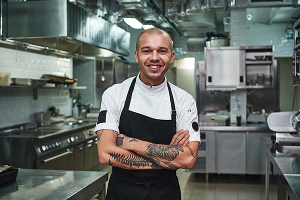 Cheerful young chef in apron